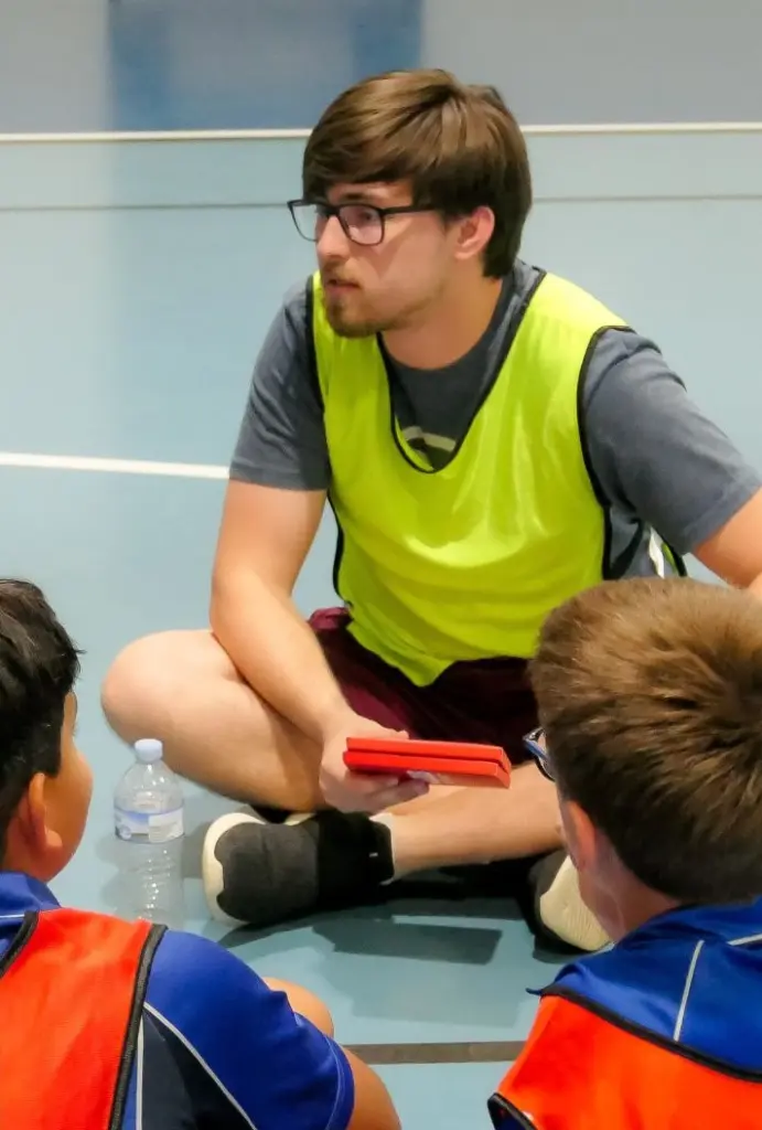 A leader running a game with primary-aged children