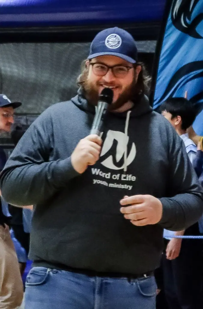 A Word of Life team member speaking into a microphone